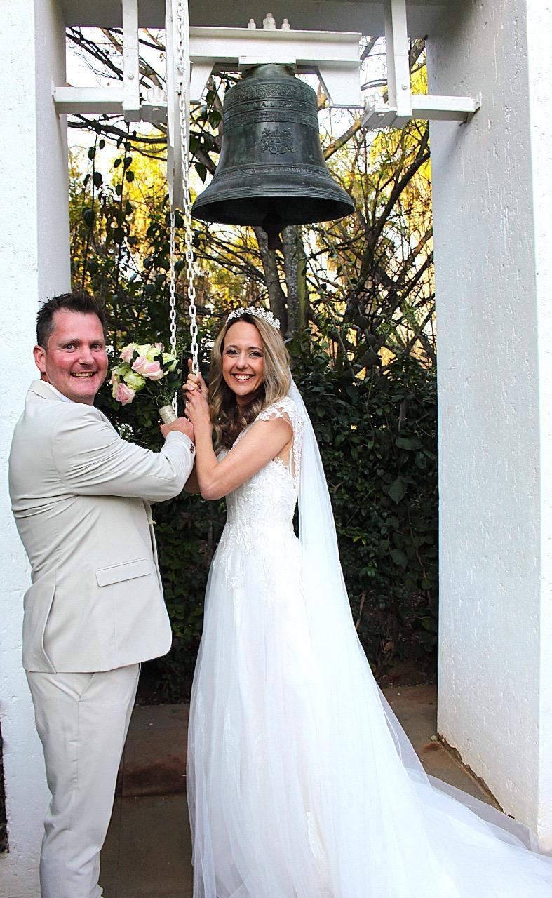 Bride and groom ringing the bell